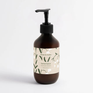 Flacon ambré avec pompe noire de la crème hydratante pour les mains "Santal Epicé" de Rose et Jules, soin bio et naturel pour des mains douces au parfum de gingembre.